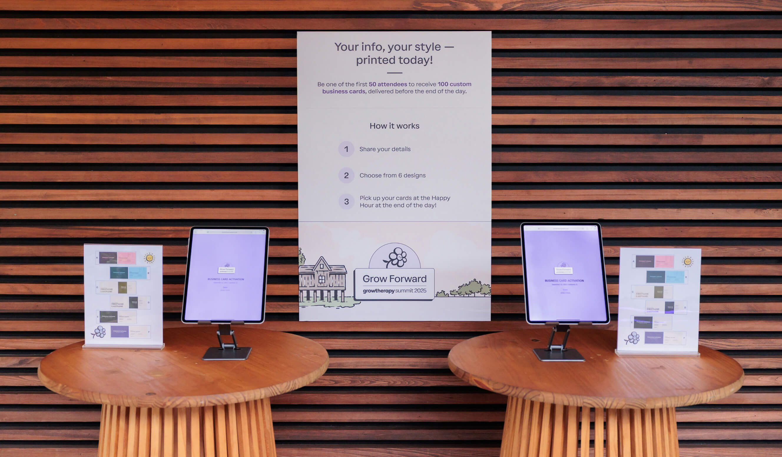 The business card station at Grow Forward, where guests could select from several business card designs and customize them with their information. Two tablets flank and poster that explains the details of the business-card-making process. Next to each tablet, two signs showing business card designs.
