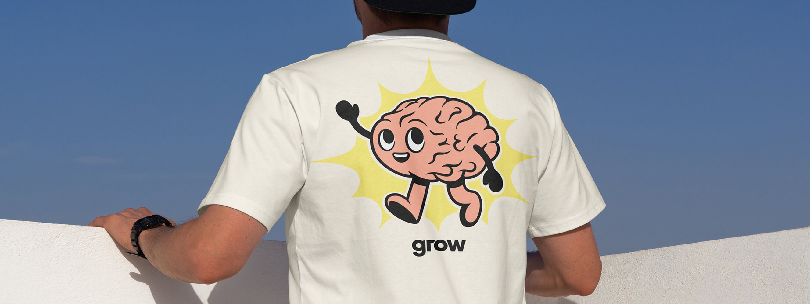 Photo of the back of a man's shirt with a cute brain on it, representing the neurodivergent ERG at Grow Therapy.